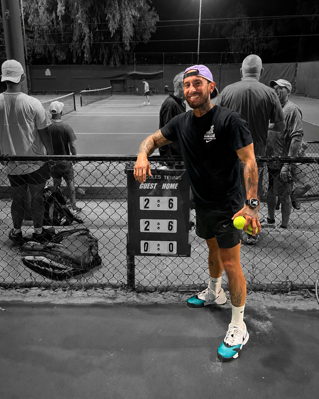 Coach Sebastian Yturbe smiling courtside at night
